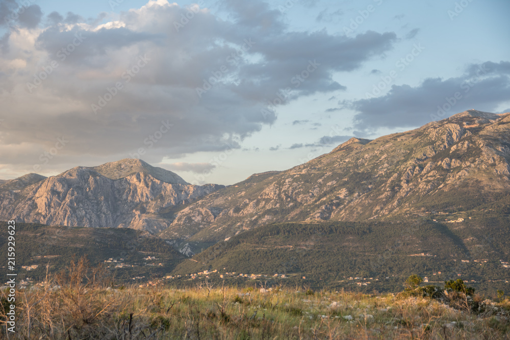 Fototapeta premium Sunset lights over the sea and mountains
