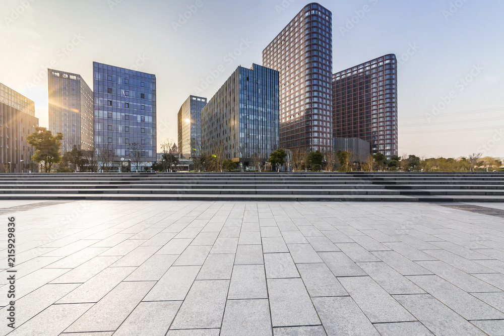 Panoramic skyline and modern business office buildings with empty road,empty concrete square floor Panoramic skyline and modern business office buildings with empty road,empty concrete square floor