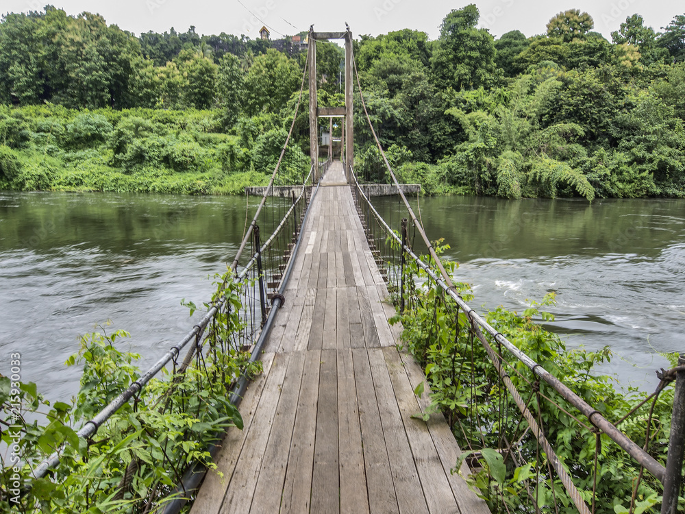 A suspension bridge over the River Kwai Noi, in Thong Pha Phum Province, eastern Thailand A suspension bridge over the River Kwai Noi, in Thong Pha Phum Province, eastern Thailand