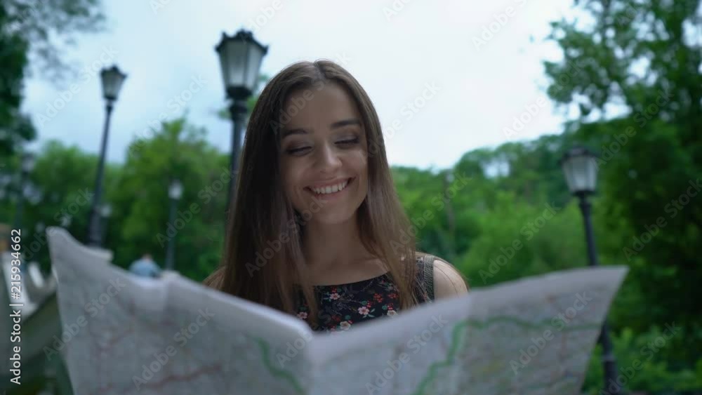 Girl tourist looking at map, successfully finds way to historical attraction Girl tourist looking at map, successfully finds way to historical attraction