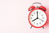 Red vintage alarm Clock show 8 O'Clock with copy space on pink background
