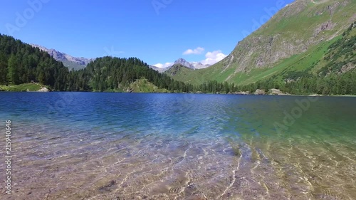 Alpine lake in mountain, beautiful lake and forest. Engadine, Switzerland photo