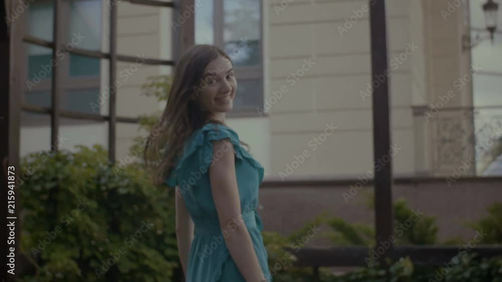 Lifestyle portrait of charming long broown hair woman in stylish dress posing and smiling in summer park. Elegant charming brunette female looking at camera with playful radiant smile. Lifestyle portrait of charming long broown hair woman in stylish dress posing and smiling in summer park. Elegant charming brunette female looking at camera with playful radiant smile.