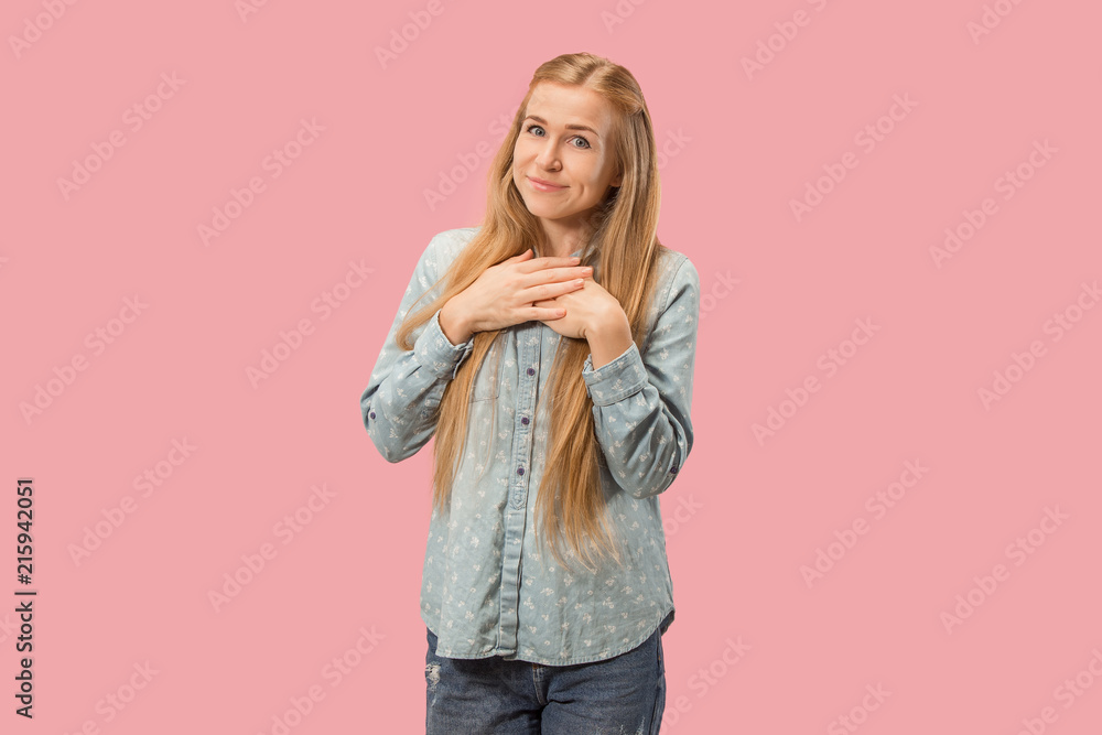 The happy business woman standing and smiling against pink background. The happy business woman standing and smiling against pink background.