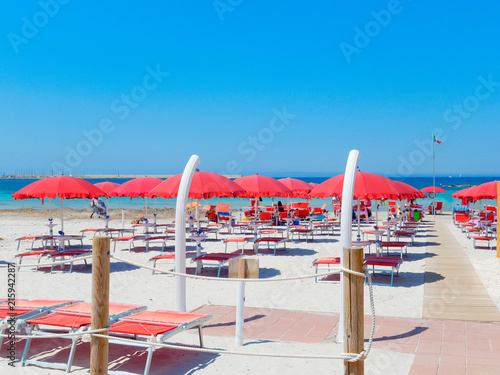 Alghero beach, Sardinia. Italy. Sea view, umbrellas and sun loungers.