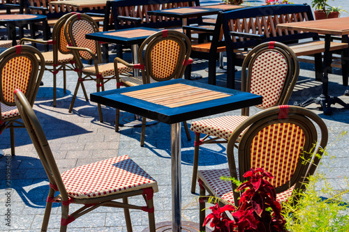 Chairs and tables in cozy outdoor cafe at summer