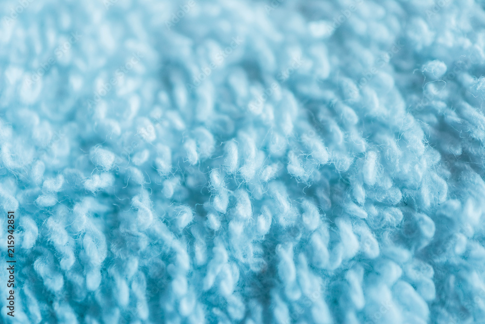 Obraz premium A white bath towel, blue abstract soft texture closeup.