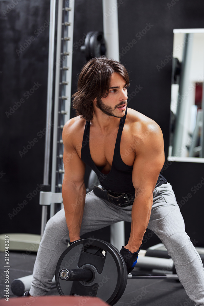 Muscular bearded man lifting barbell weight Muscular bearded man lifting barbell weight