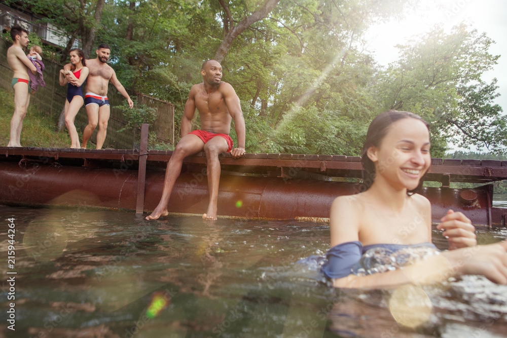 Fototapeta premium Enjoying river party with friends. Group of beautiful happy young people at the river together