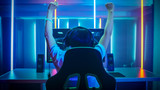 Professional Gamer Playing and Winning in First-Person Shooter Online Video Game on His Personal Computer. Footage Fade out into Bokeh. Room Lit by Neon Lights in Retro Arcade Style. Cyber Sport.