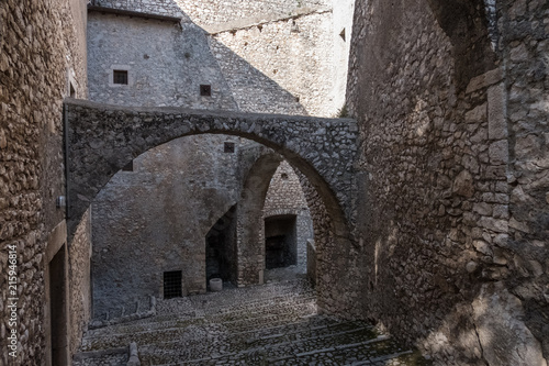 Arches and stairs of an old stone wall castle.