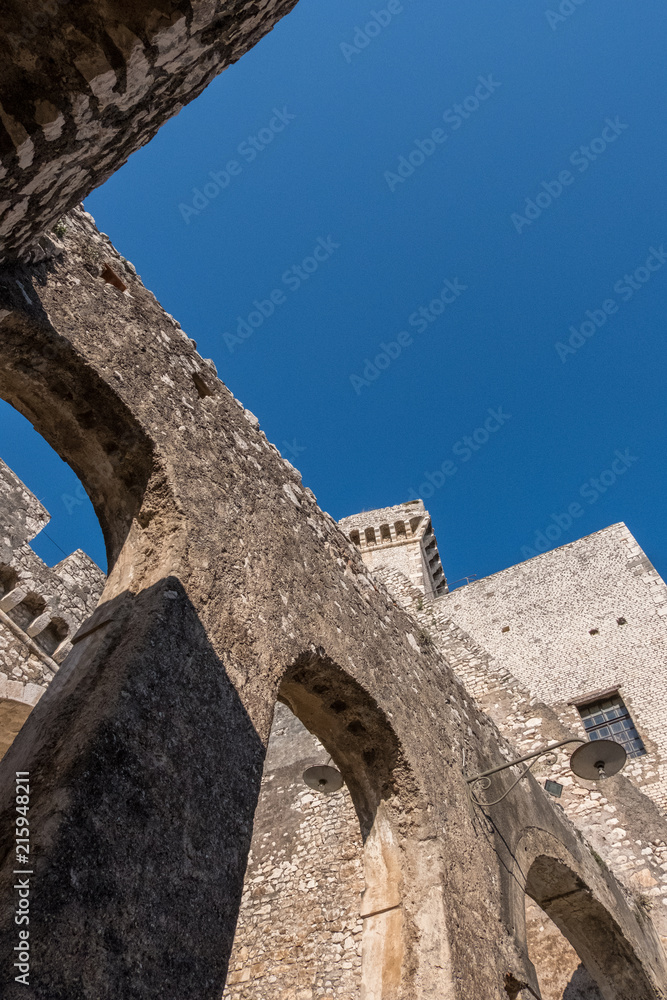 Vertical photo of vintage castle detail construction with blue sky background.