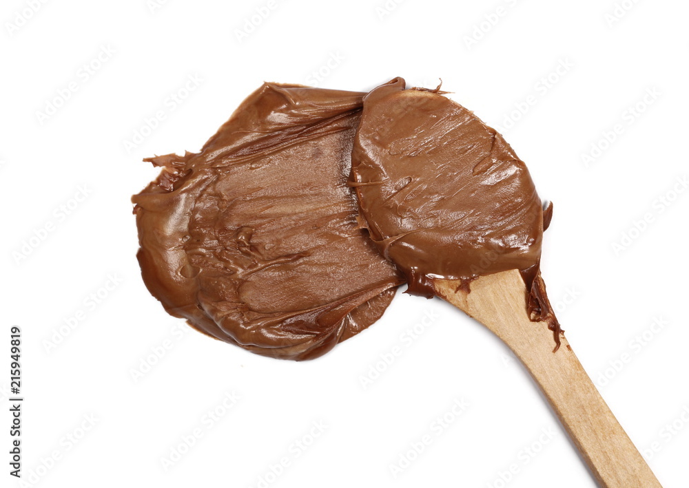 Cream chocolate spreading with wooden spoon isolated on white background, top view Cream chocolate spreading with wooden spoon isolated on white background, top view