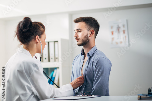 Wallpaper Mural Doctor Examining Patient in Office Torontodigital.ca