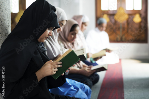 Muslims reading from the Quran photo
