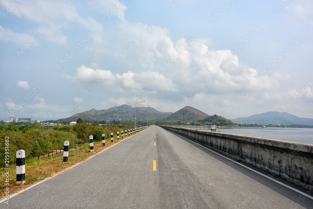 The road on dam on the hillside is the background. The road on dam on the hillside is the background.
