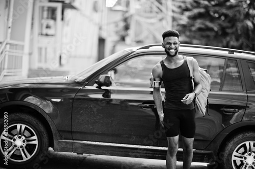 African american male athlete sport man with backpack against his black suv car before training. © AS Photo Family