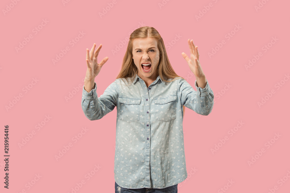 Portrait of an angry woman looking at camera isolated on a pink background Portrait of an angry woman looking at camera isolated on a pink background
