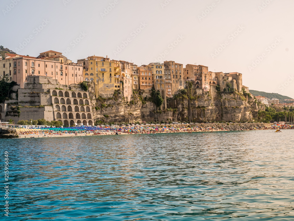 The town of Tropea in Italy seen from the sea on to the beach and old buildings in city center.