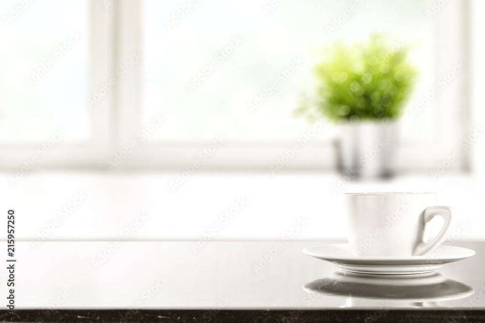 Obraz premium desk of free space and window background with small plant 