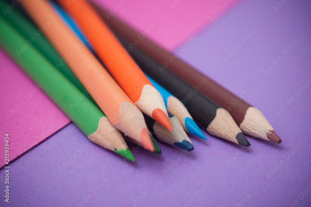 closeup of colouring pencils on color background closeup of colouring pencils on color background