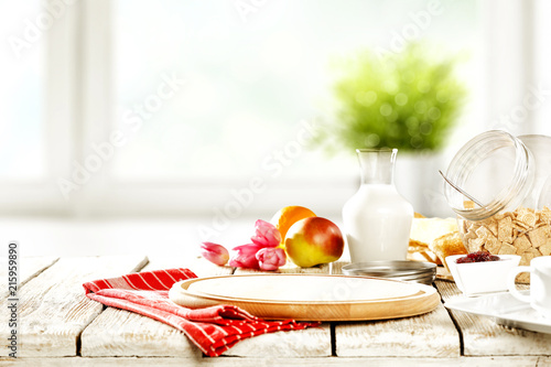 Continental breakfast and blurred background of white window with green plant. Free space for your decoration. 