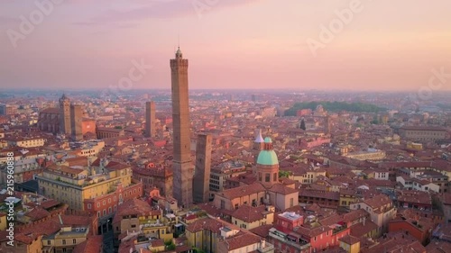 bologna city aerial view at sunrise flying backwards from two towers photo
