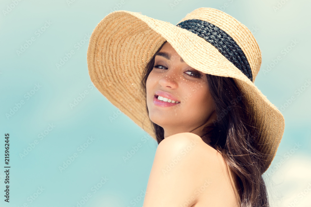 happy attractive girl posing in straw hat