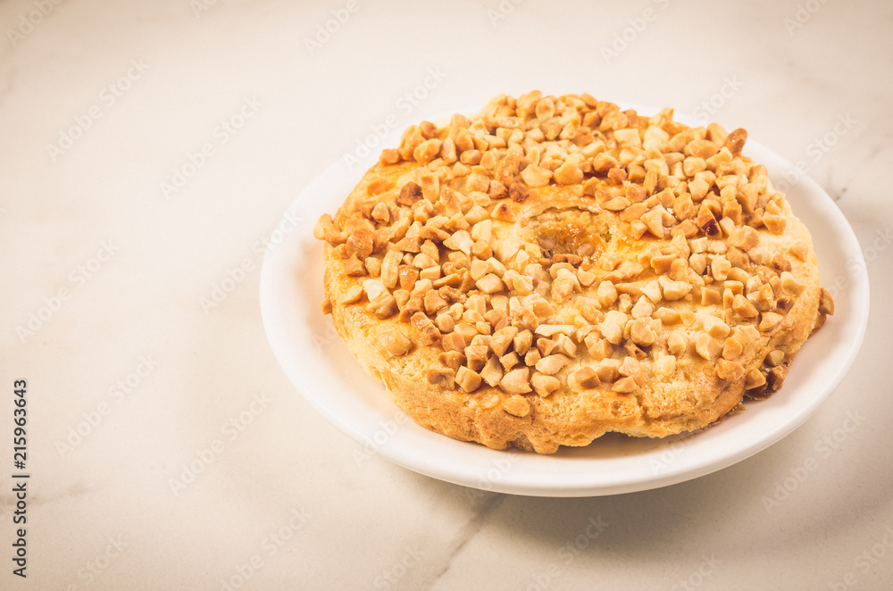 Baking with nuts on a white bowl and marble table/Baking with nuts on a white bowl and marble background, selective focus Baking with nuts on a white bowl and marble table/Baking with nuts on a white bowl and marble background, selective focus