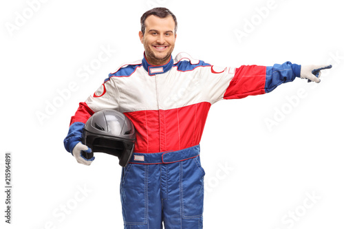 Race driver holding a helmet and pointing