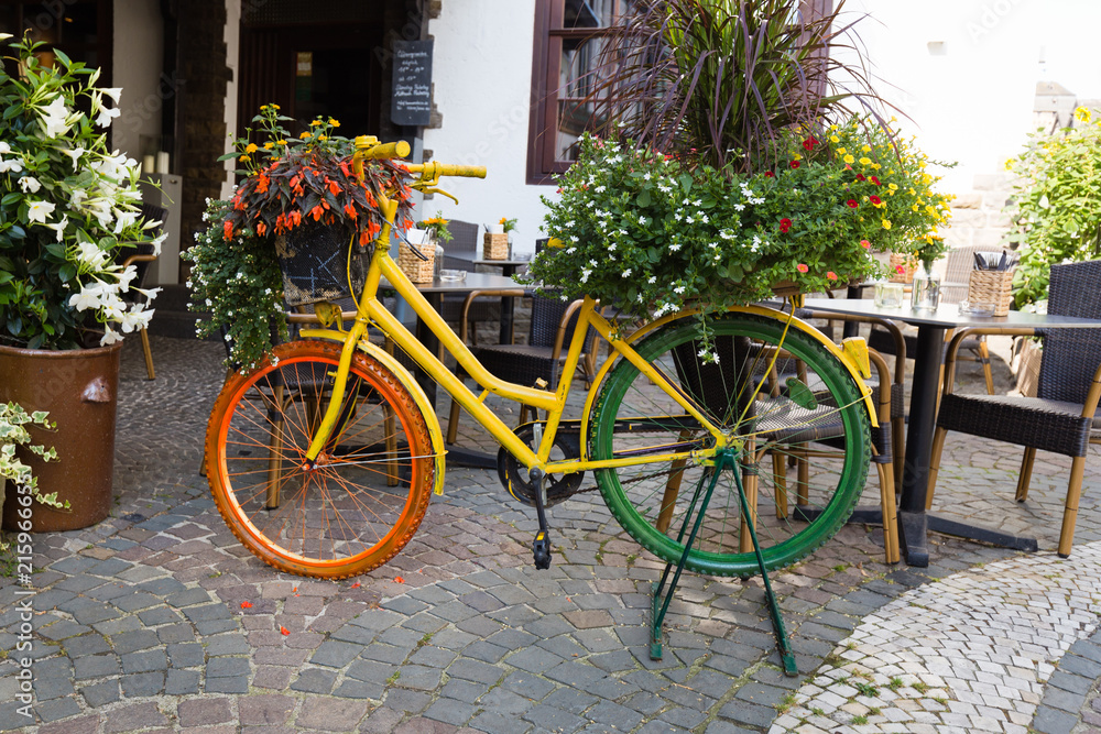 Colourful bicycle used as a flower vase in Linz, Germany