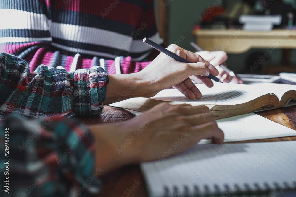 Fototapeta premium Two students are reading and learning together.