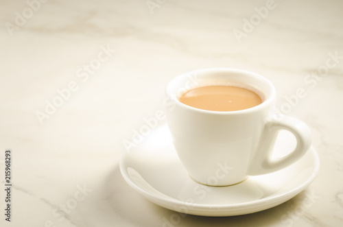 white cup of tea with milk/white cup of tea with milk on a marble background, selective focus and copy space