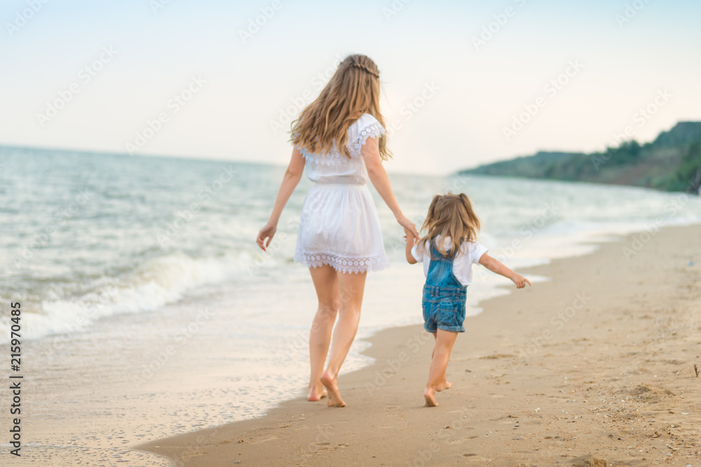 Happy mother and kid on the beach