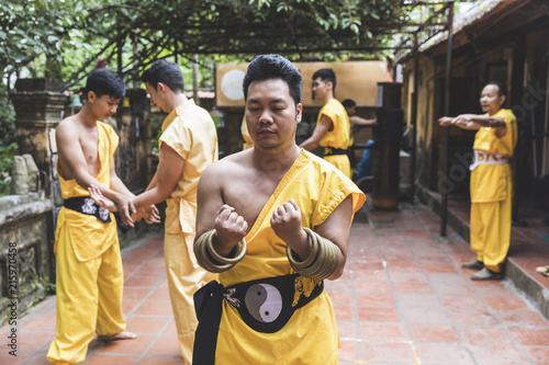 Vietnam, Hanoi, men exercising kung fu photo