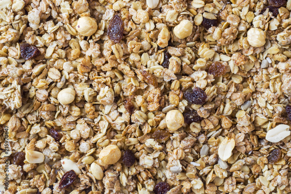 Background of Muesli Breakfast with oat flakes raisins. Close-up view of the crispy granules. The concept of Healthy eating. Background of Muesli Breakfast with oat flakes raisins. Close-up view of the crispy granules. The concept of Healthy eating.