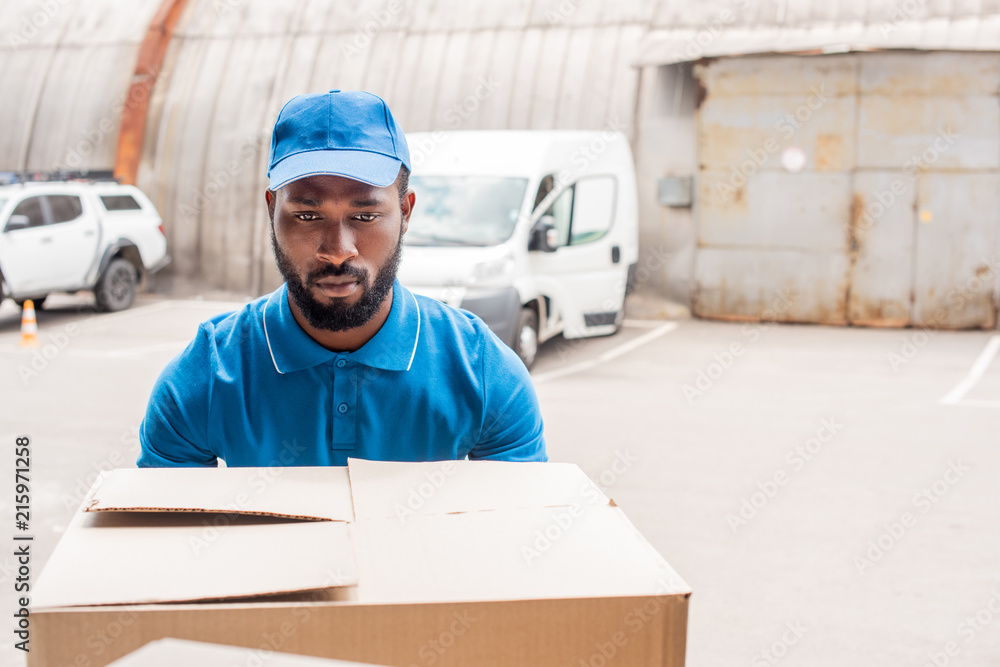 african american courier carrying big box african american courier carrying big box