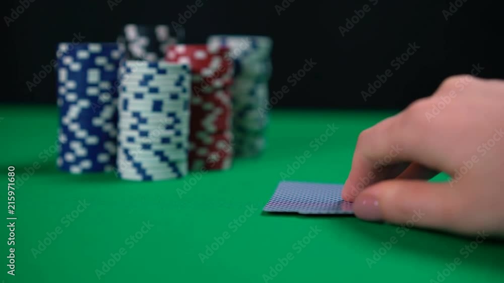 Poker player folding cards, low chances of winning, retreat, avoiding risk. Gambling, card game, money loss Poker player folding cards, low chances of winning, retreat, avoiding risk. Gambling, card game, money loss
