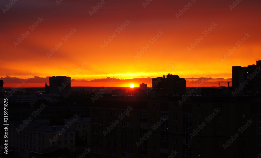 Red sunset on a cityscape background