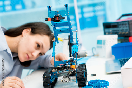 Young woman in CNC and robotics laboratory