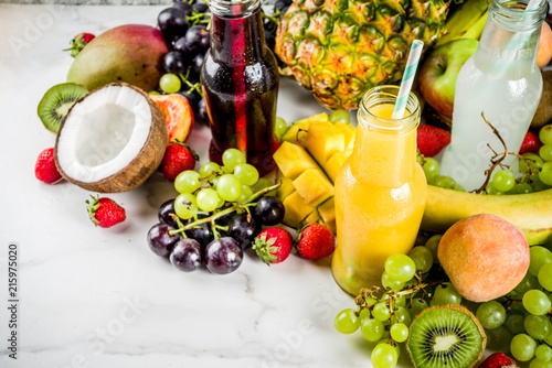 Different fruit juices smoothies concept  summer vitamins diet  with tropical fruits and berries on a light background 