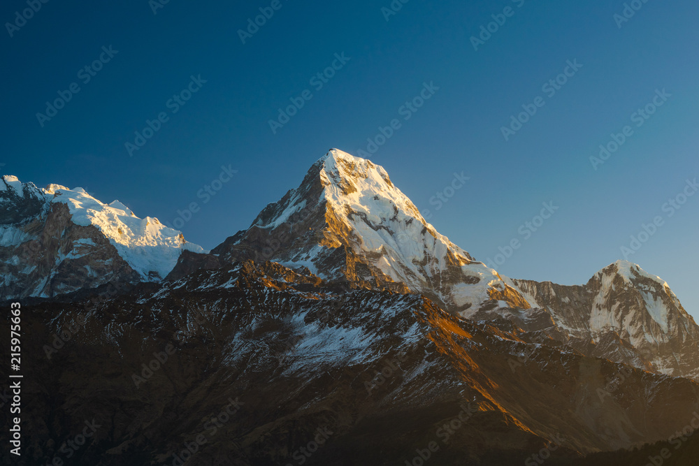 Fototapeta premium Machapuchhare mountain top in the Himalaya range, seen from Poon Hill tower in Nepal.