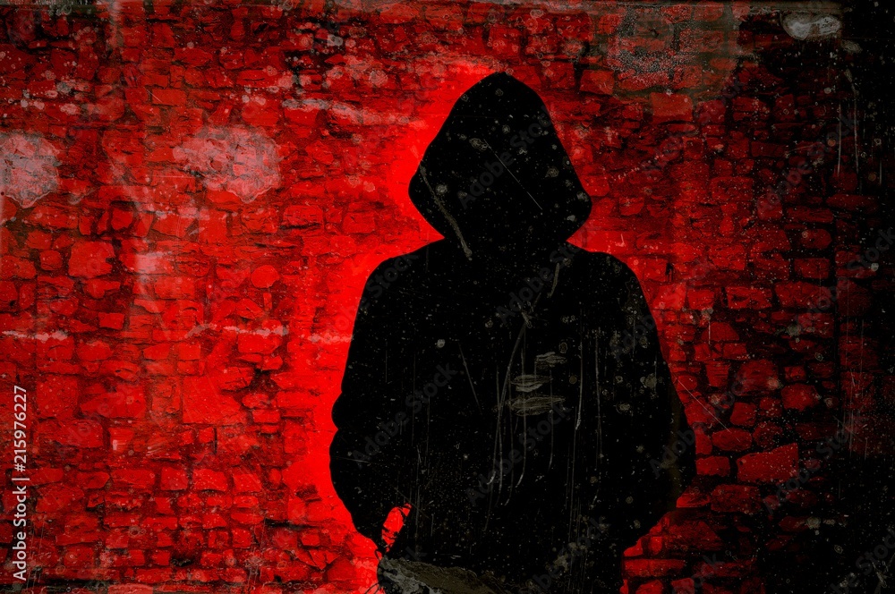 Male figure with hood on red wall background. Hacker concept. Photos |  Adobe Stock