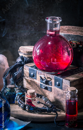 Magic concept. Red potion in bottle