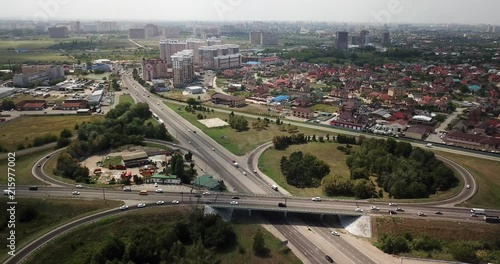 Aerial shot of a car moving on highway overpass, ringway, roundabout photo