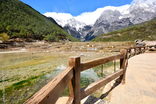 Baishuihe waterfall in front of Yulong or Jade Dragon Snow Mountain in the background, Lijiang, China