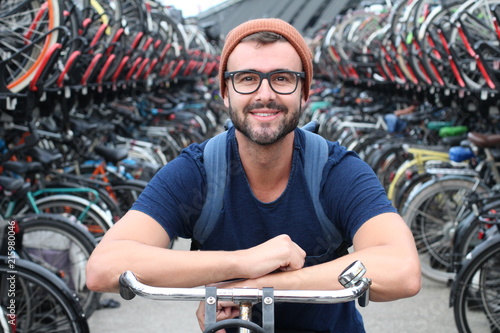 Man giving smiling at bicycle parking lot
