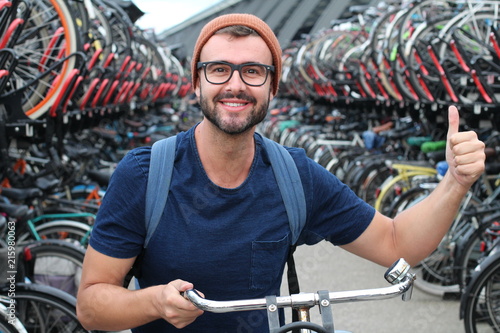 Man giving thumbs up at bicycle parking lot