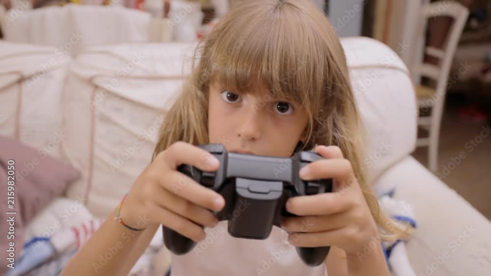 A cute little girl at home, playing with a controller (joysticks and keypad) in front of a computer screen. Fast movement, expertise at a young age.
A cute little girl at home, playing with a controller (joysticks and keypad) in front of a computer screen. Fast movement, expertise at a young age.