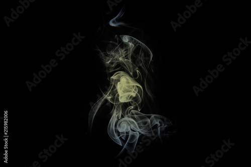 Beauty gold smoke on dark background. Slightly coloured smoke texture on a black background